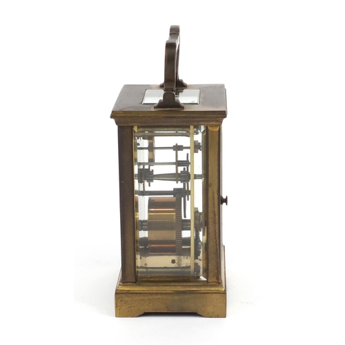 2337 - Brass cased carriage clock with enamelled dial and Roman Numerals, 12cm high excluding the handle