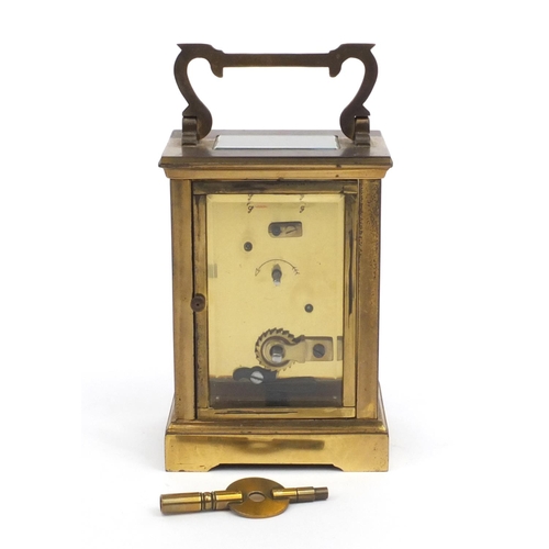 2337 - Brass cased carriage clock with enamelled dial and Roman Numerals, 12cm high excluding the handle