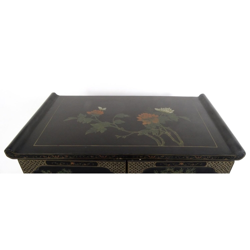 2026 - Oriental black lacquered two door side cabinet decorated in relief with soap stone, the top hand pai... 