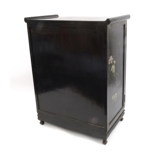 2026 - Oriental black lacquered two door side cabinet decorated in relief with soap stone, the top hand pai... 
