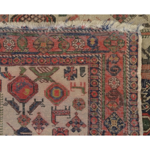 2029 - Rectangular Middle Eastern carpet with geometric border, the central field decorated with mythical c... 