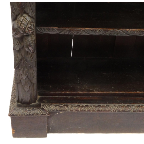 2017 - Carved oak bookcase with five adjustable shelves, with lion mask supports, 123cm high x 118cm wide x... 