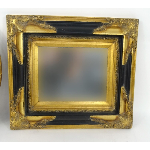 44 - Ornate ebonised and gilt wall hanging mirror and an oval gilt framed bevelled edged mirror