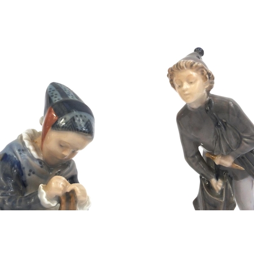 2105 - Two Royal Copenhagen figures, one of a boy holding an umbrella and one of a girl seated knitting, fa... 