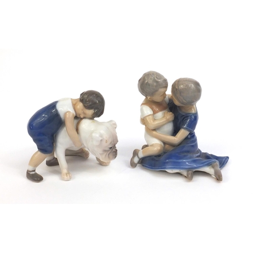 2106 - Two Royal Copenhagen figures, one of a boy holding a dog and one of a boy and girl, factory marks to... 