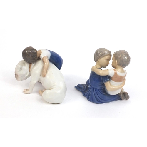 2106 - Two Royal Copenhagen figures, one of a boy holding a dog and one of a boy and girl, factory marks to... 