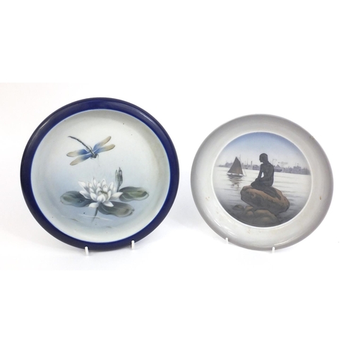2108 - Two Royal Copenhagen shallow dishes, one with a girl seated on a rock before a harbour and one with ... 