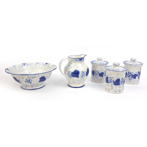 2236 - Group of hand painted Poole pottery blue leaf patterned items, comprising jug and bowl, three storag... 