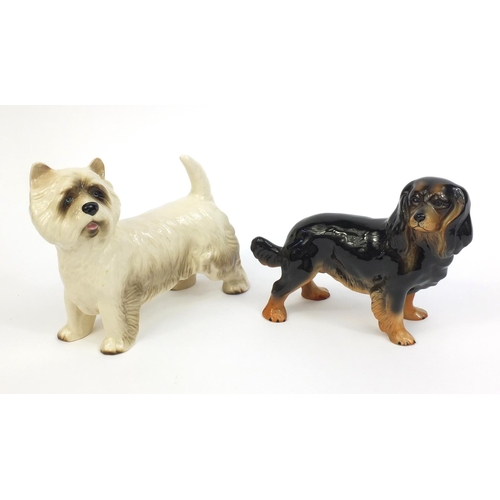 2114 - Two Beswick dogs one with original paper label, the other with factory marks to the base, the talles... 