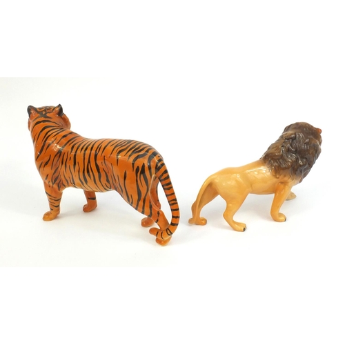 2111 - Two Beswick animals comprising a tiger and a lion, both with factory marks to the base, the tallest ... 