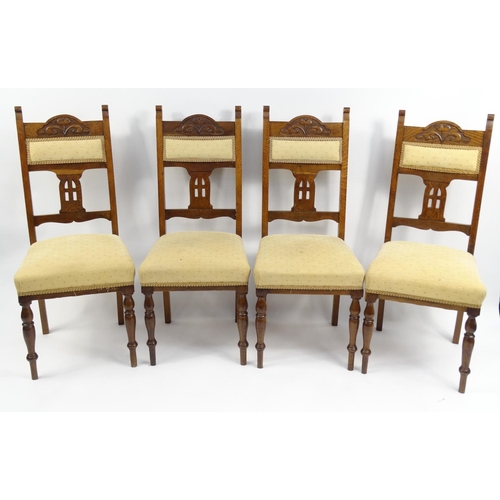 19 - Set of four Arts & Crafts style carved oak dining chairs, with cream and gold upholstered backs and ... 