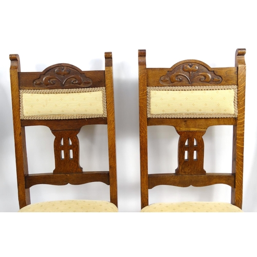 19 - Set of four Arts & Crafts style carved oak dining chairs, with cream and gold upholstered backs and ... 