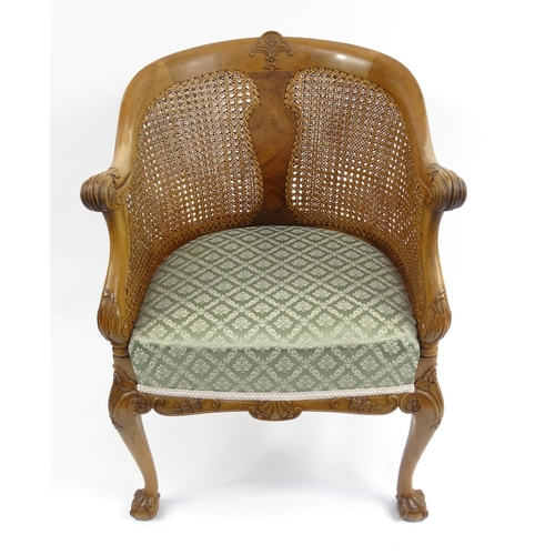 5 - Carved walnut double bergère tub chair with green and gold upholstered seat