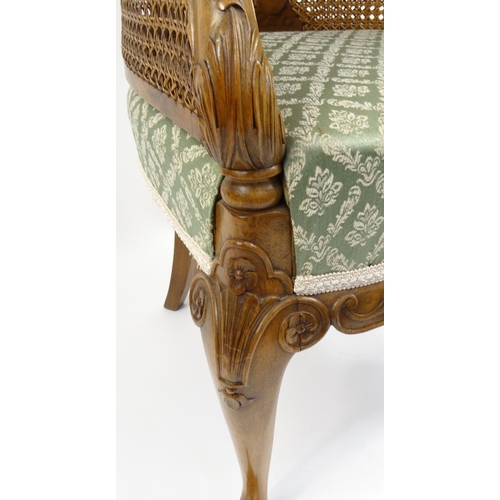5 - Carved walnut double bergère tub chair with green and gold upholstered seat