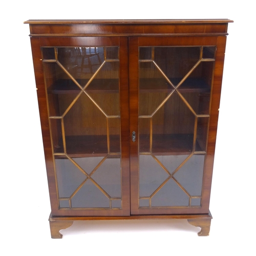 43 - Glazed yew wood bookcase, 110cm high x 85cm wide x 33cm deep