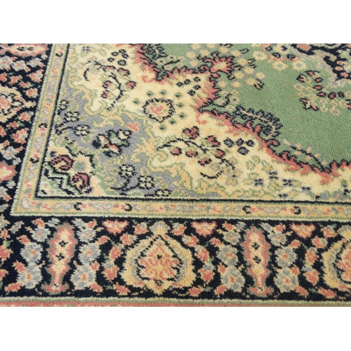 56 - Green ground floral rug, approximately 170cm x 120cm