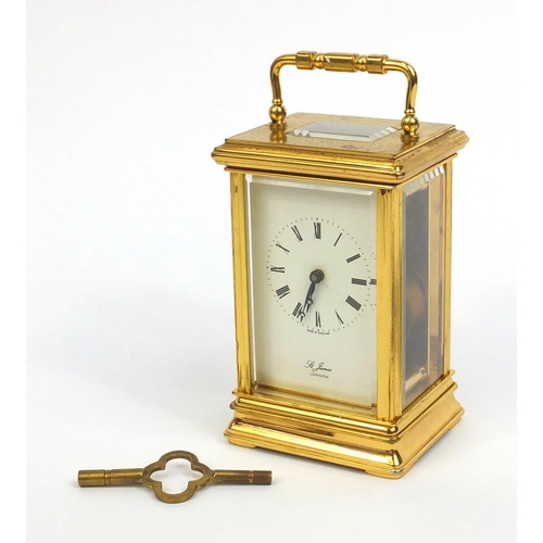 2334 - St James of London brass cased carriage clock with swing handle and bevelled glass panels, 13cm high... 