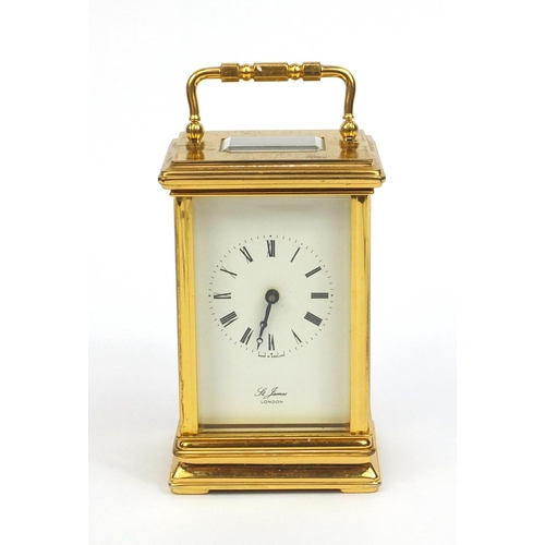 2334 - St James of London brass cased carriage clock with swing handle and bevelled glass panels, 13cm high... 