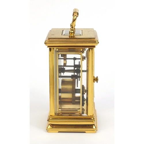 2334 - St James of London brass cased carriage clock with swing handle and bevelled glass panels, 13cm high... 