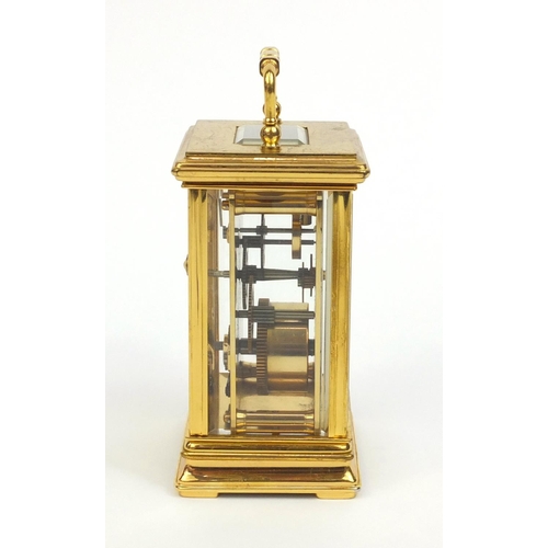 2334 - St James of London brass cased carriage clock with swing handle and bevelled glass panels, 13cm high... 