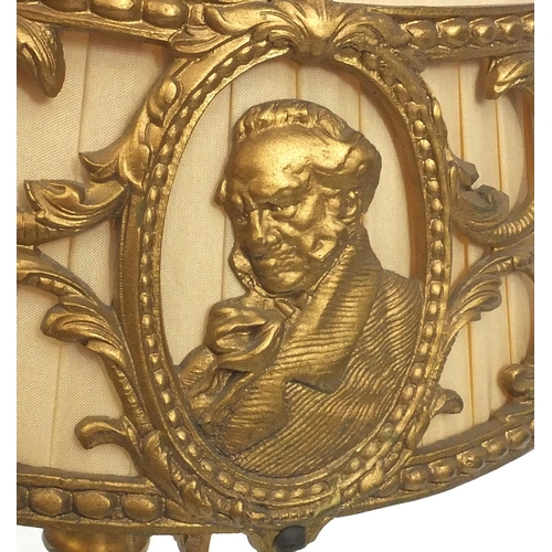 2163 - Gilt metal table lamp, the shade decorated with busts of gentlemen, 46cm high