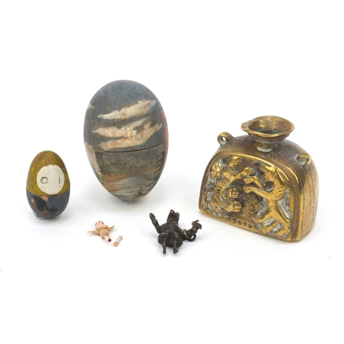 2353 - Russian? brass inkwell embossed with mythical creatures, together with two painted eggs - one housin... 