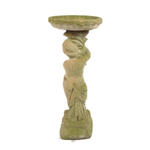 2069 - Garden stoneware statue in the form of a robed putti holding bird bath a loft, 88cm high