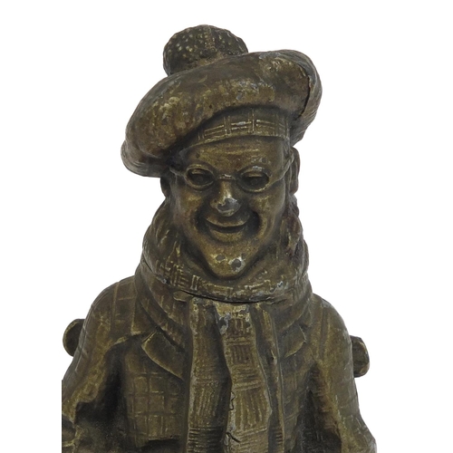 2369 - Novelty table lighter in the form of a seated gentleman, 14cm high