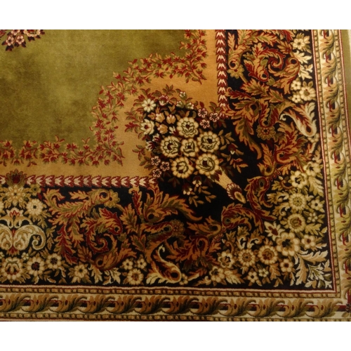 2013 - Large rectangular Prado Orient carpet with floral decoration onto a green ground, label to the under... 