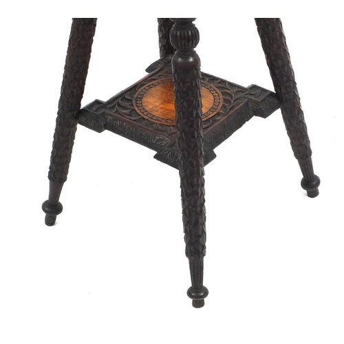 47 - Carved hardwood occasional table with under tier, 56cm high