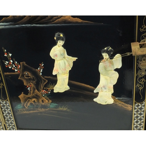 60 - Oriental black lacquered two door cupboard, relief decorated in Mother of Pearl of figures, 110cm hi... 