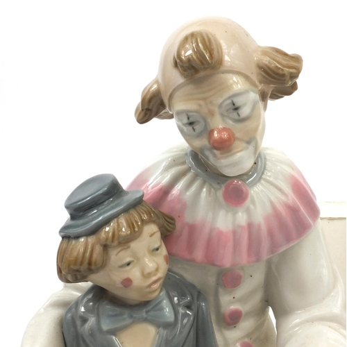 2096 - Boxed Nao figure group of a clown sat with a child playing a concertina, factory marks to the base, ... 