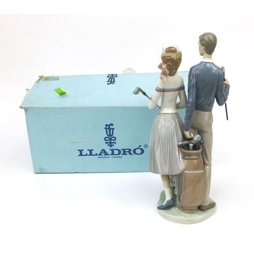 2092 - Boxed Lladro figure group of a couple playing golf, factory marks to the base, 33cm high