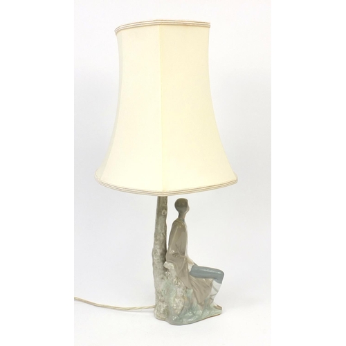 2090A - Nao porcelain table lamp and shade modelled as a seated boy