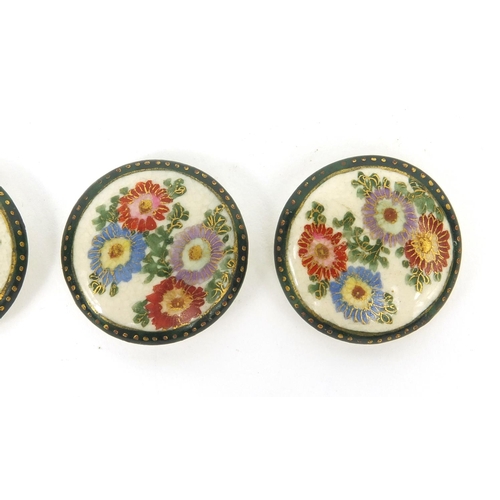 784 - Four Japanese Satsuma pottery buttons hand painted with Chrysanthemums, each 2.5cm in diameter