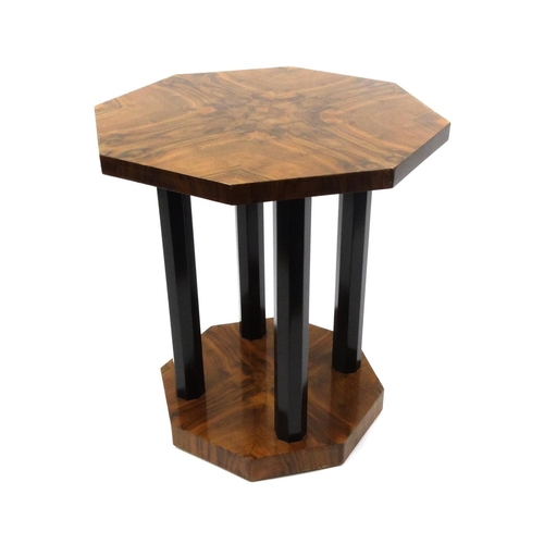 2021 - Art Deco octagonal occasional table raised on ebonised columns, 67cm high x 59cm diameter