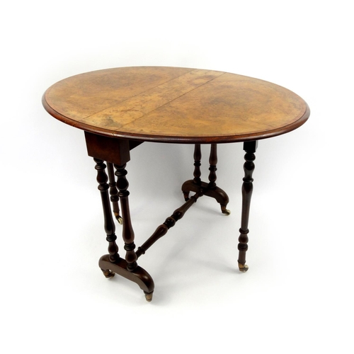 2001 - Victorian burr walnut Sutherland table, the oval cross banded top raised on baluster shaped supports... 