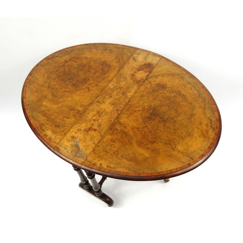 2001 - Victorian burr walnut Sutherland table, the oval cross banded top raised on baluster shaped supports... 