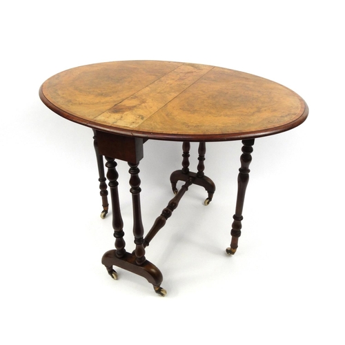 2001 - Victorian burr walnut Sutherland table, the oval cross banded top raised on baluster shaped supports... 