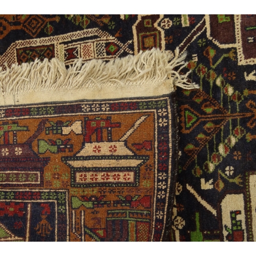 2025 - Rectangular Middle Eastern rug, the border and central field decorated with tanks, 205cm x 115cm
