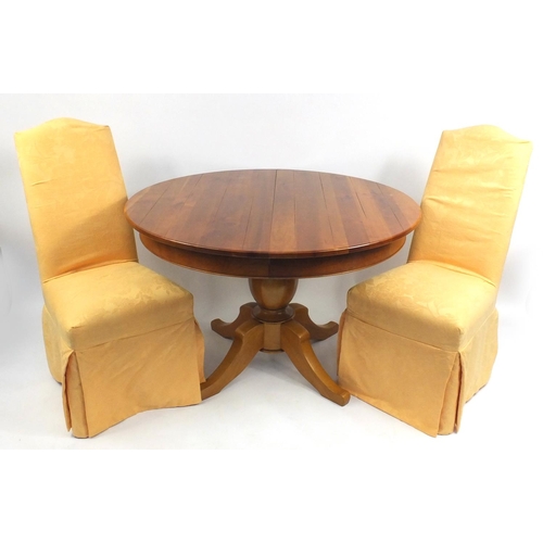 10 - Multiyork circular extending dining table with two extra leaves and eight upholstered chairs, the ta... 