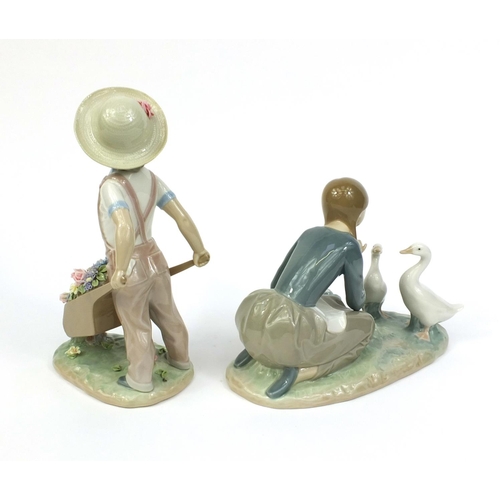 2107 - Two Lladro figures one of a boy with a wheelbarrow full of flowers and one of a girl knelt feeding t... 