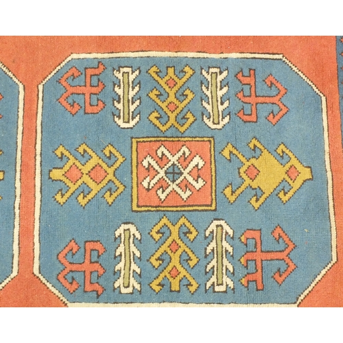 2046 - Rectangular Middle Eastern rug with geometric border and central field predominantly onto a peach gr... 