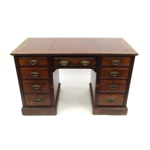 2011 - Edwardian walnut twin pedestal desk with tooled leather top above an arrangement of nine drawers, 76... 