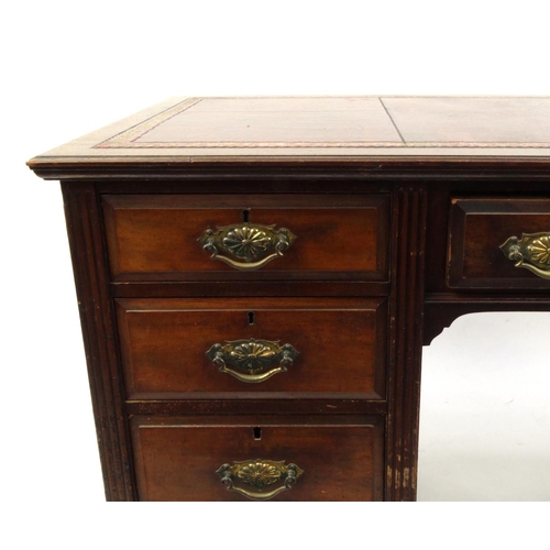 2011 - Edwardian walnut twin pedestal desk with tooled leather top above an arrangement of nine drawers, 76... 