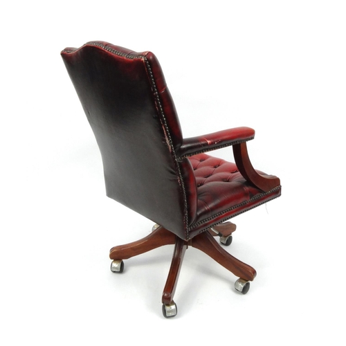 2010 - Oxblood leather button back swivelling desk chair, 100cm high