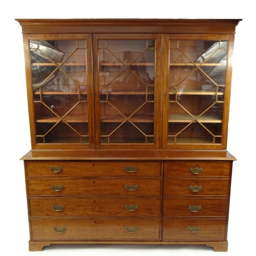2015 - Large mahogany bookcase fitted with astragal glazed doors enclosing shelves above four drawers and a... 