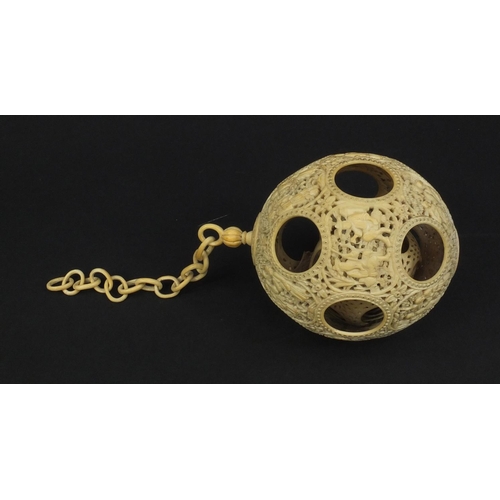 789 - Chinese Cantonese ivory layered puzzle ball on chain, the outer layer profusely carved with figures ... 