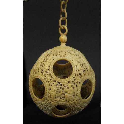 789 - Chinese Cantonese ivory layered puzzle ball on chain, the outer layer profusely carved with figures ... 