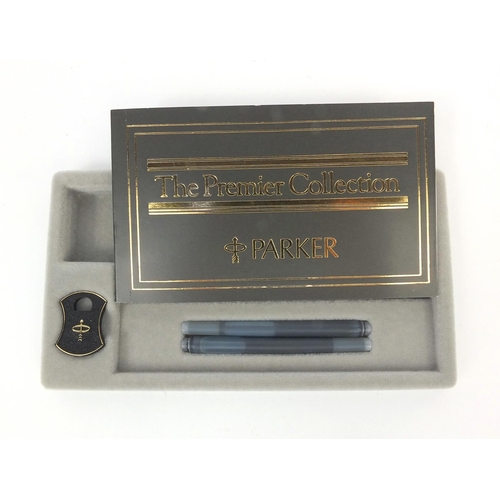 298 - Boxed 18ct gold cased Parker Premier fountain pen, with 18ct gold nib and accessories, the fountain ... 